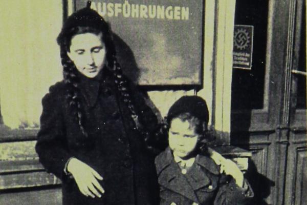 An old black and white photograph of a woman and her young daughter.